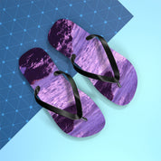 Purple wave pattern flip-flops with black straps on a blue and white background.