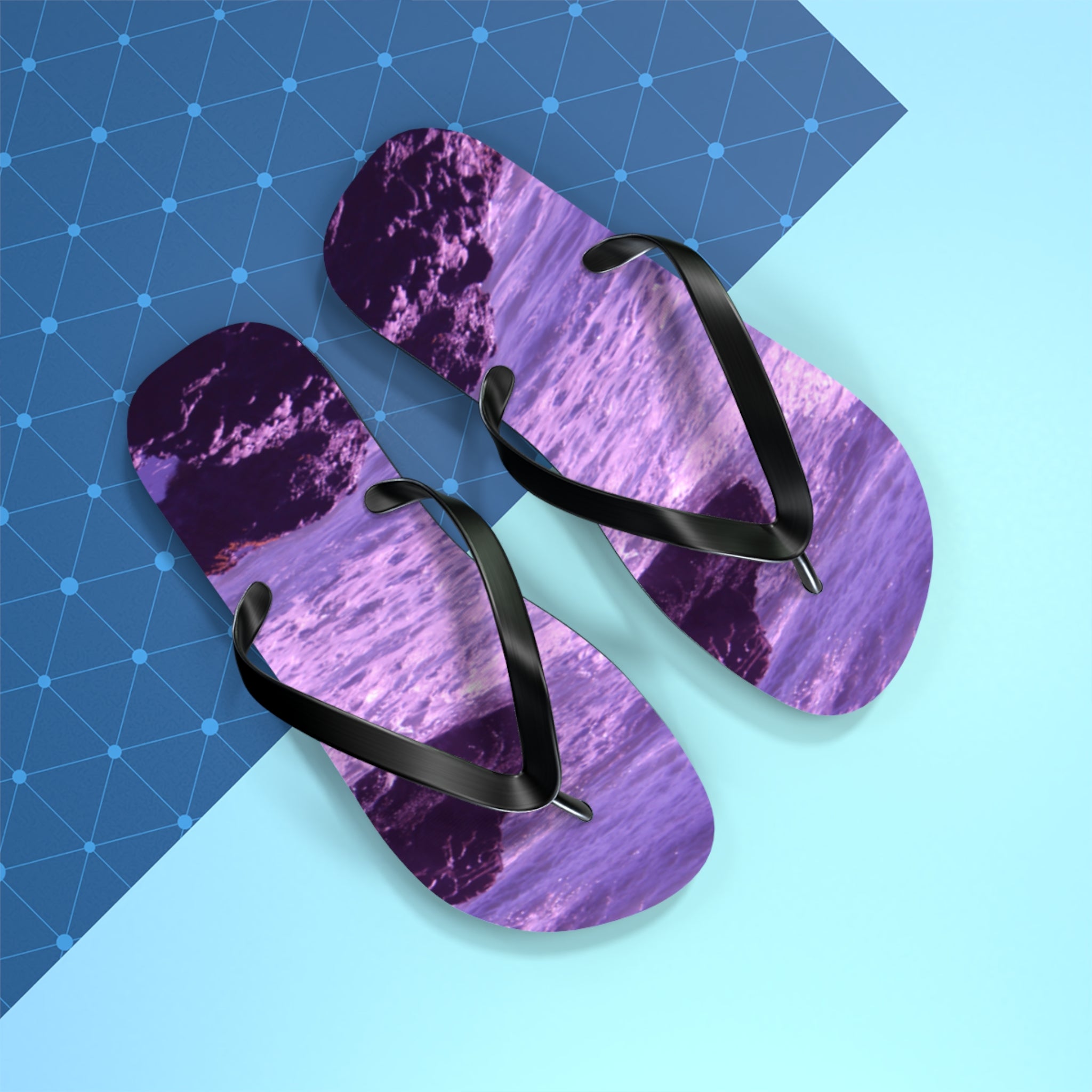 Purple wave pattern flip-flops with black straps on a blue and white background.