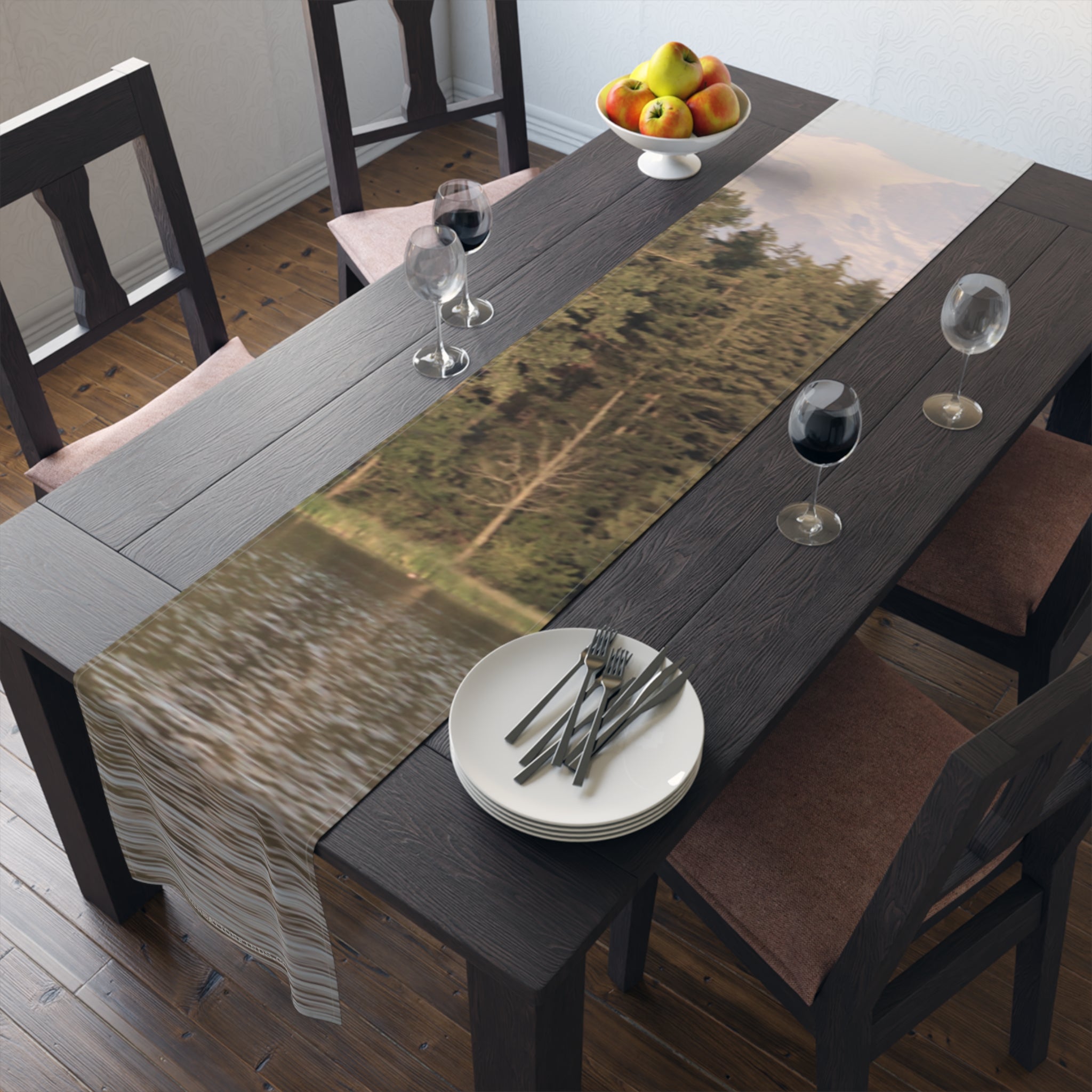 Table runner with forest and lake scene, set on a dining table.