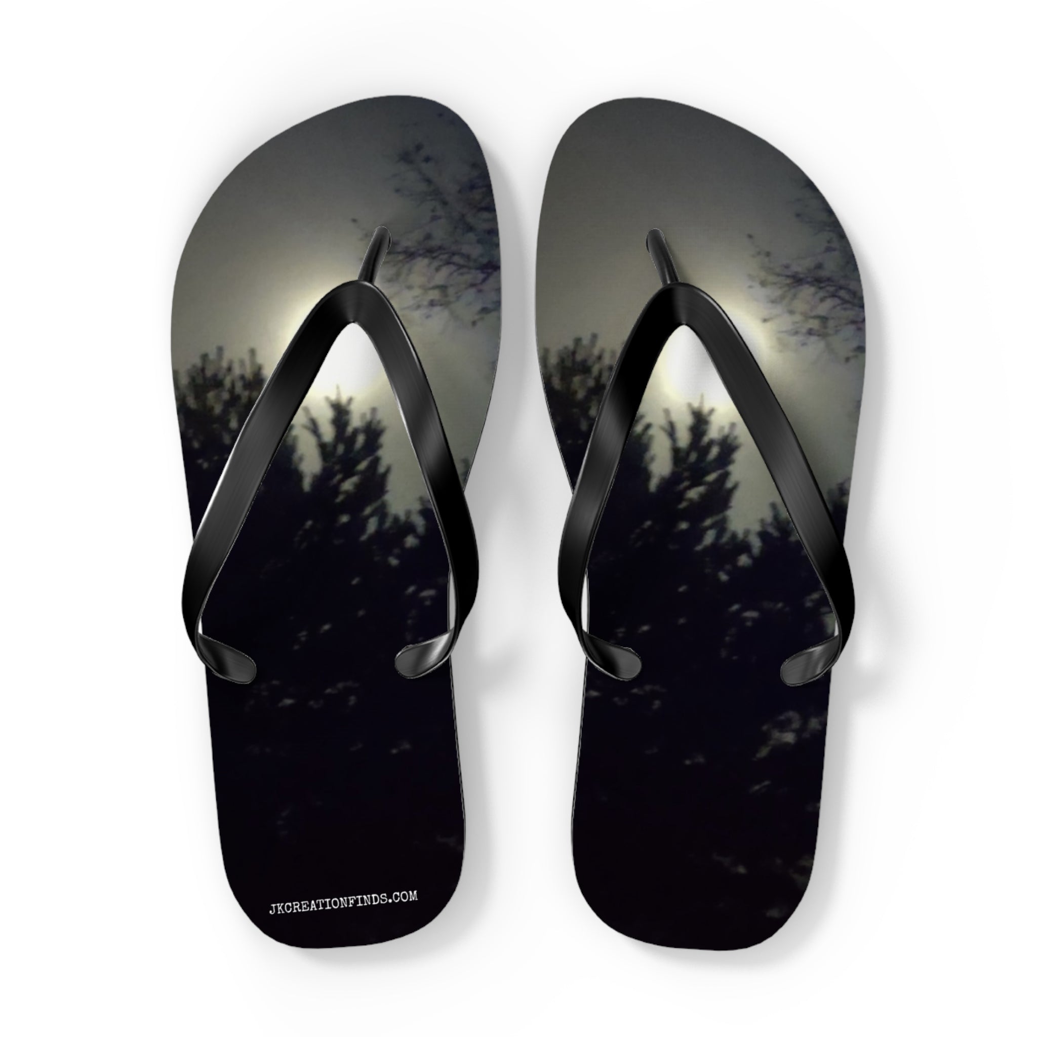 Flip-flops with a dark forest and moonlight scene on the soles.