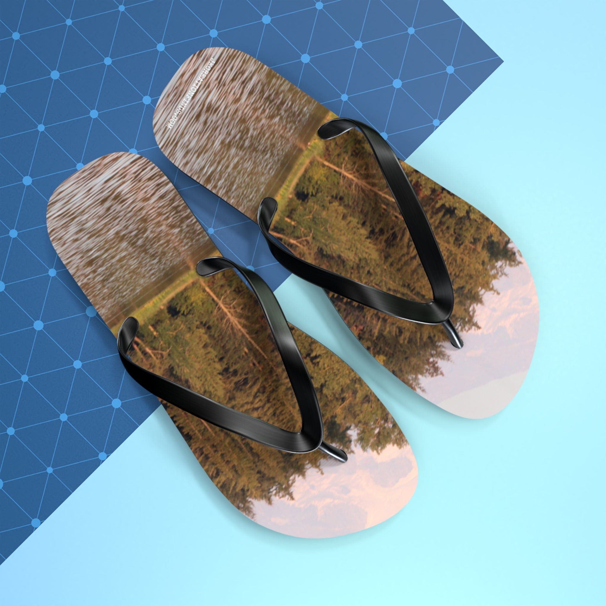 Flip-flops with a forest and lake reflection scene.