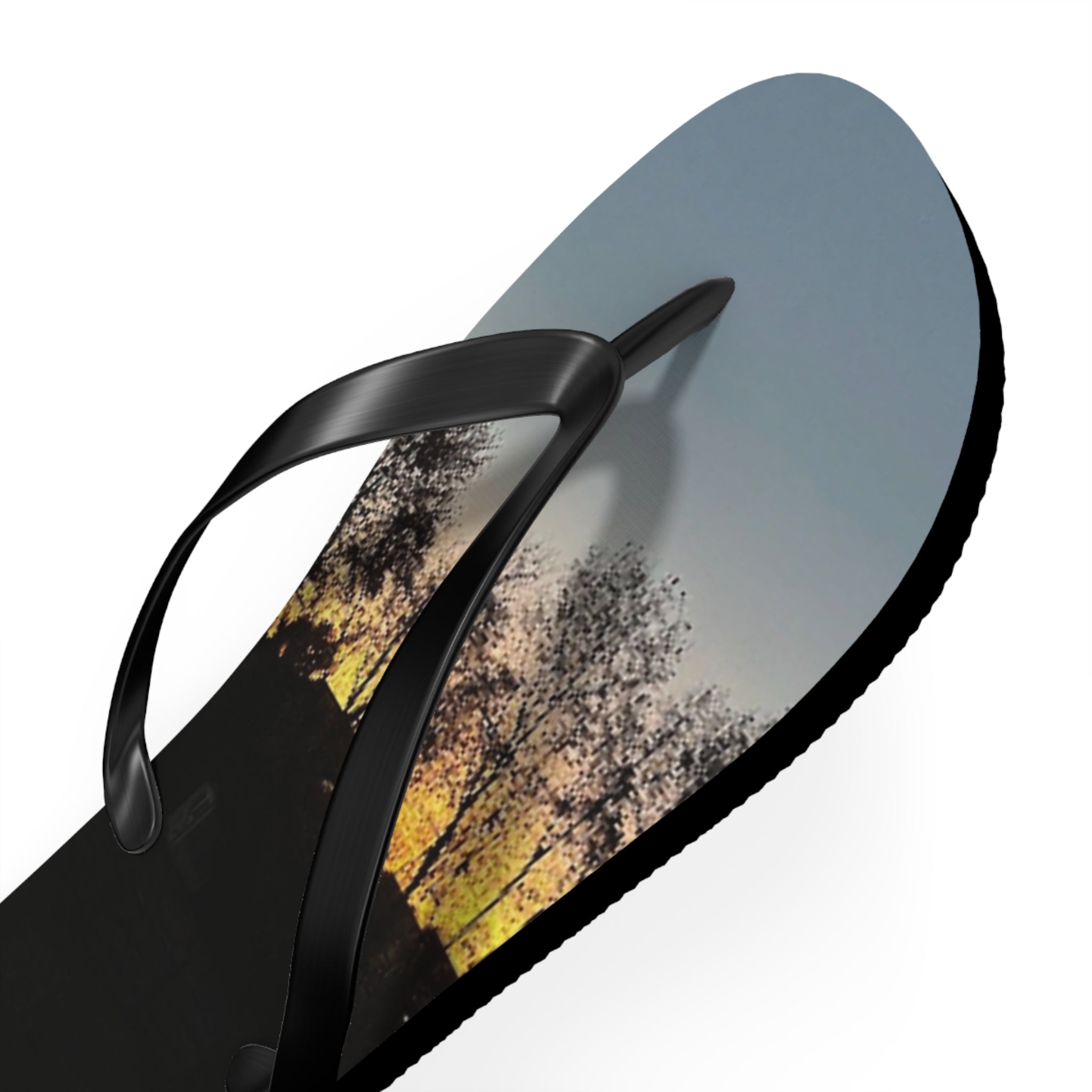 Black flip-flop with sunset landscape on the sole.