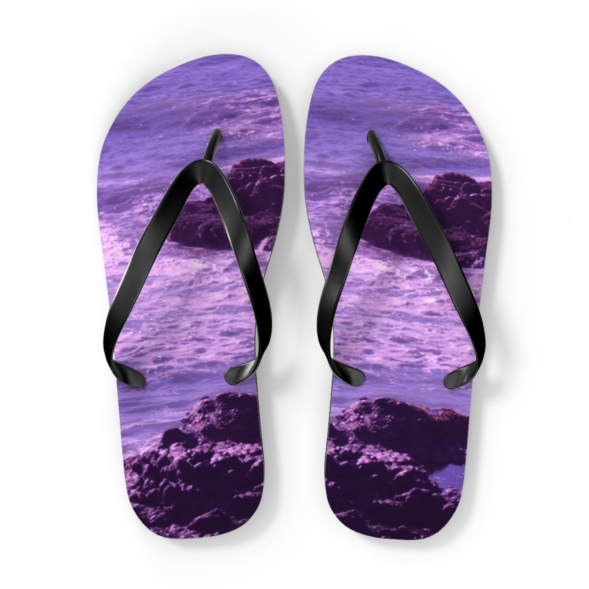 Purple flip-flops with a rocky ocean wave design.