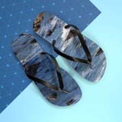 Flip-flops with a blue ocean wave pattern on a light blue and dark blue geometric background.