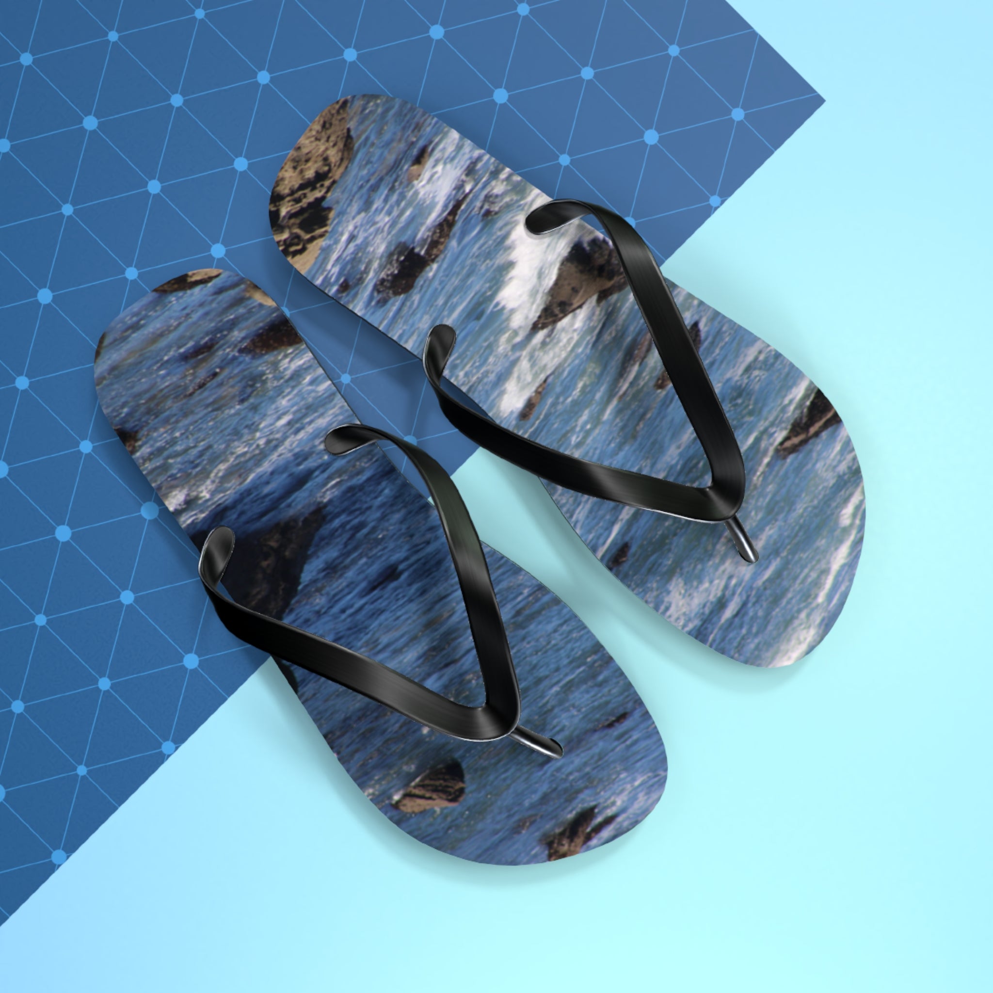 Flip-flops with a blue ocean wave pattern on a light blue and dark blue geometric background.