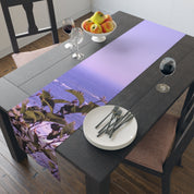 Table runner with a seascape and foliage design, set on a dining table.