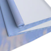 Rolled light blue fabric with a white stitched edge on a white background.