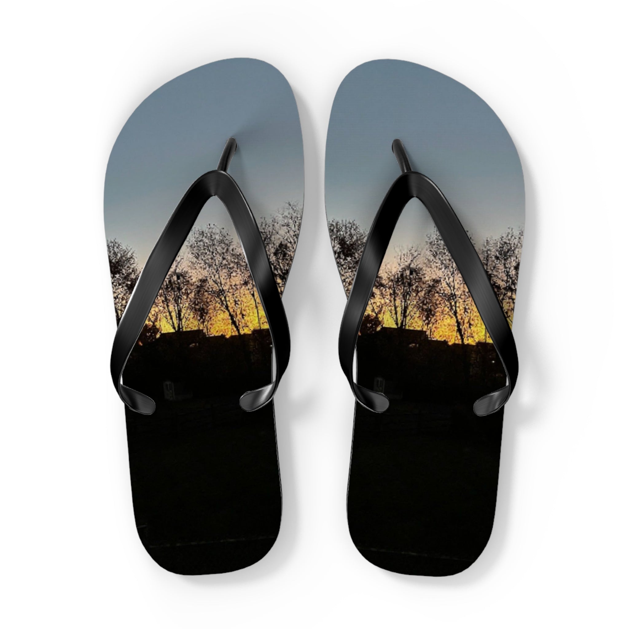 Flip-flops with a sunset landscape scene on straps.