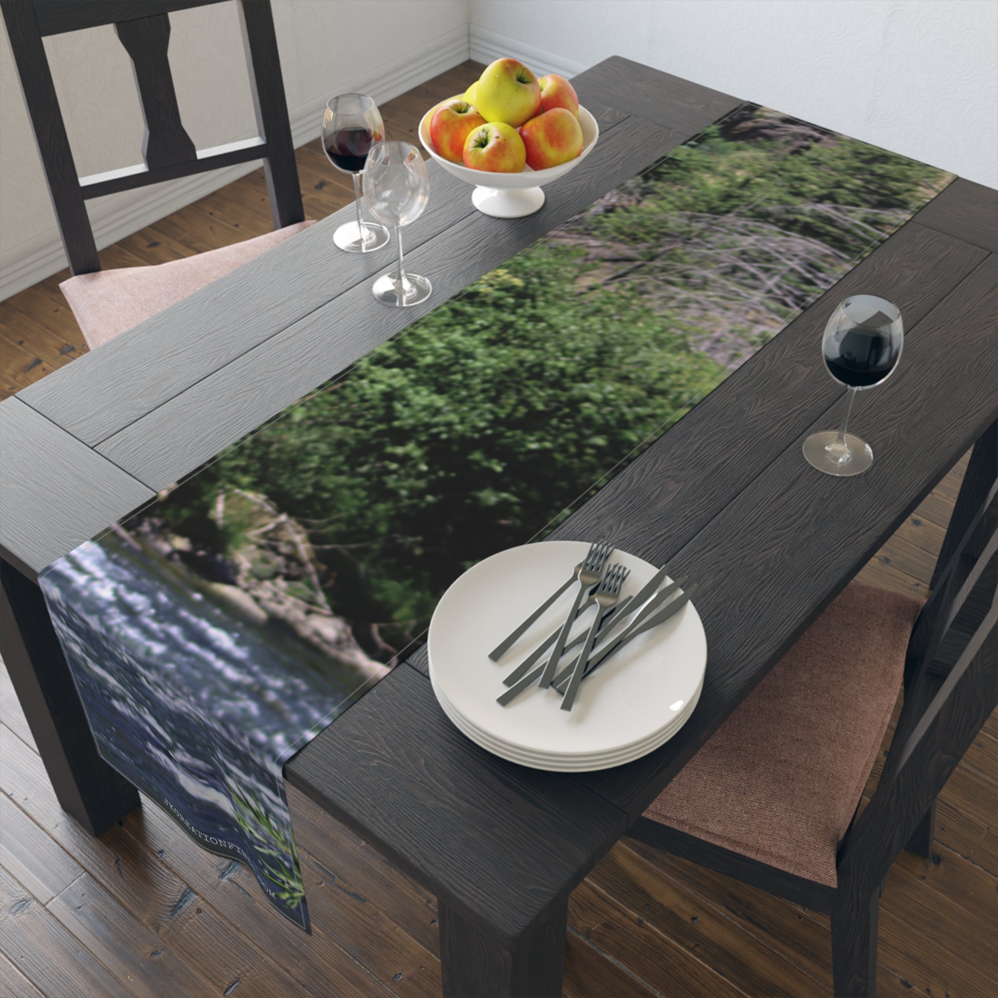 Table runner with a flowing water and green foliage landscape design.
