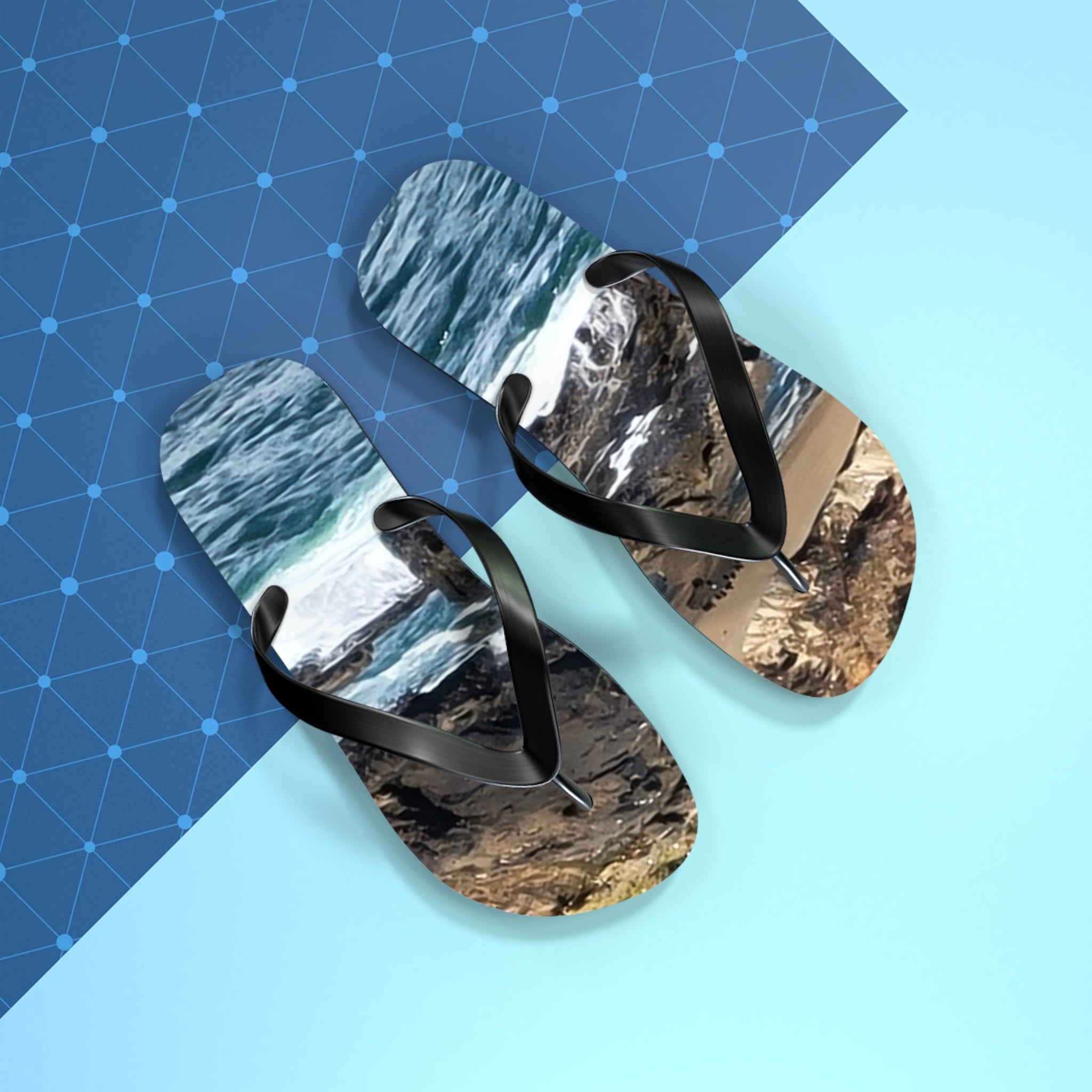 Flip-flops with ocean waves and rocky shore design on a blue patterned background.
