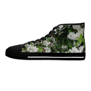 High-top sneaker with white floral pattern on black background.