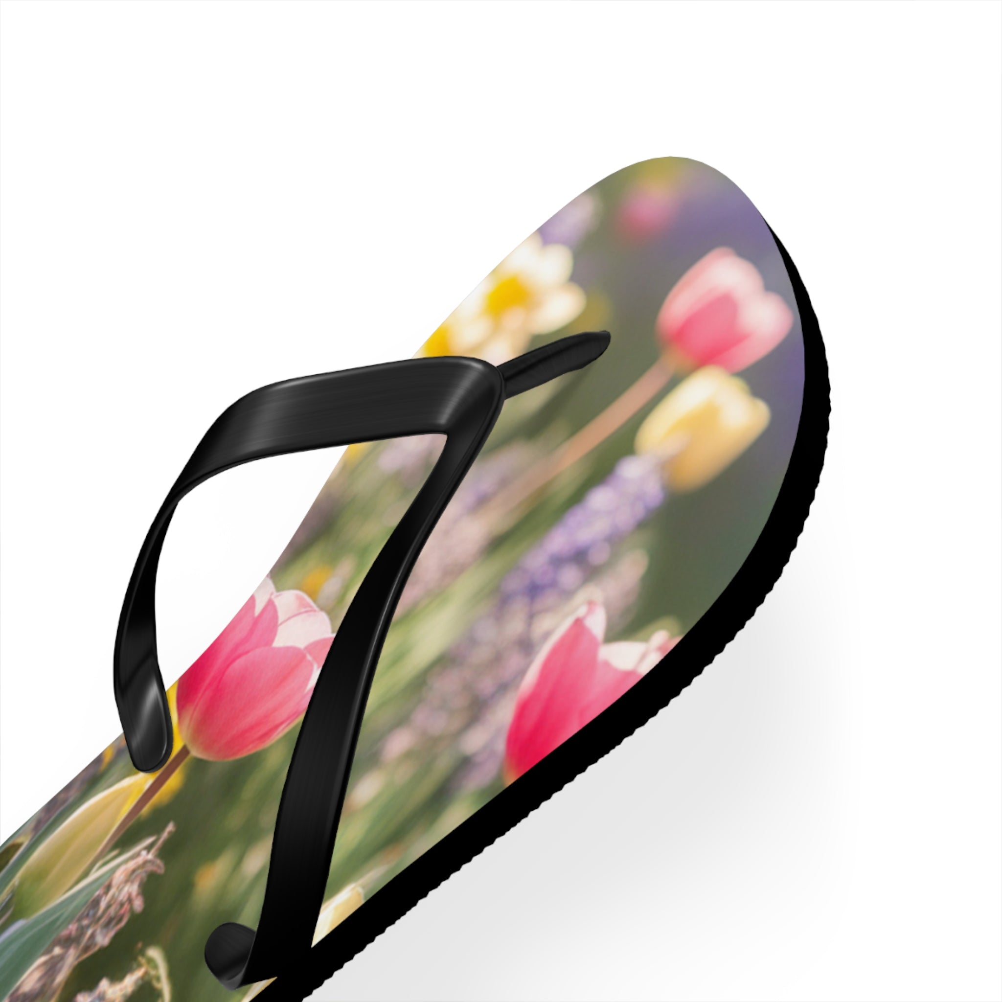Flip-flop with pink and yellow tulips and purple flowers.