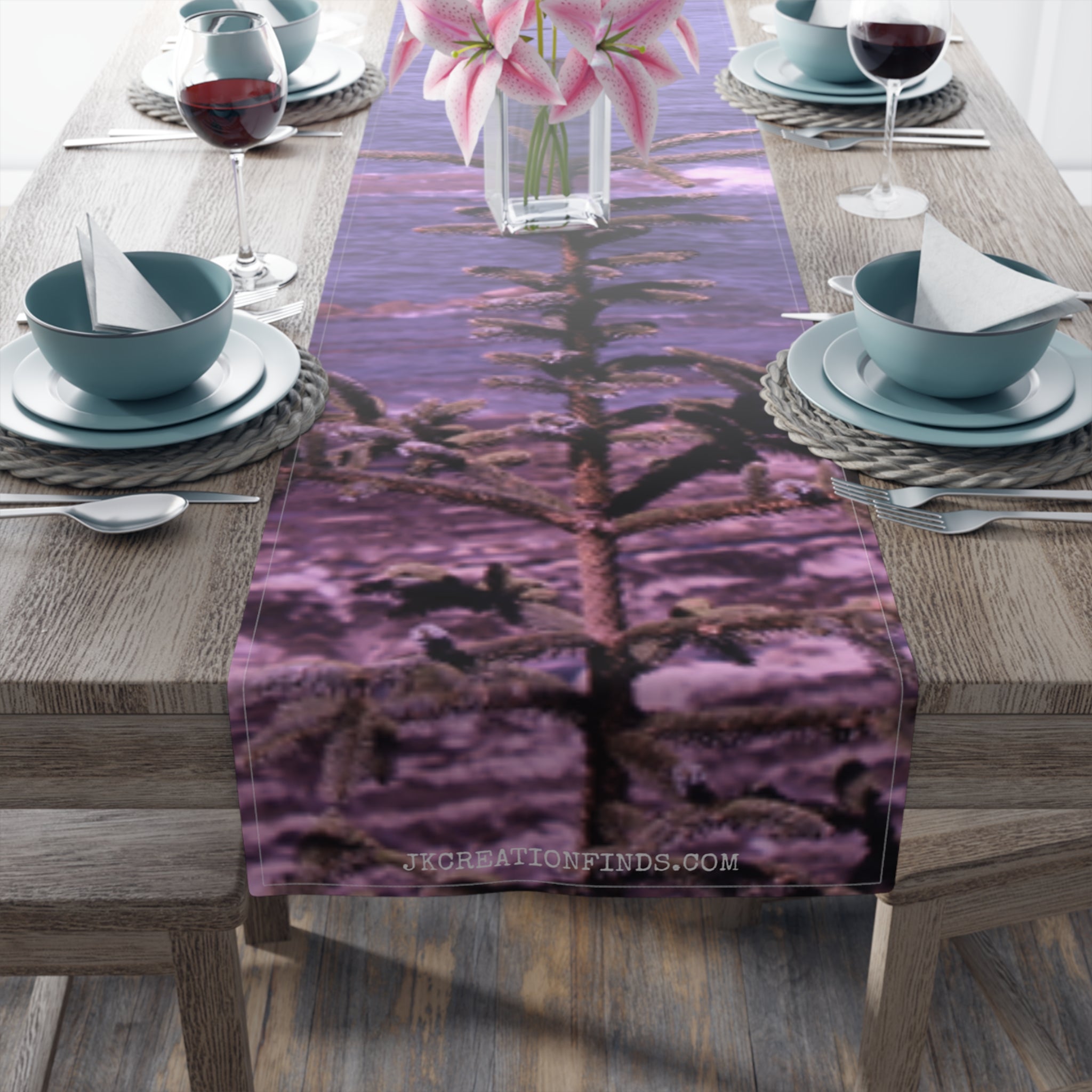 Table runner with a blurred image of a pine tree and water.