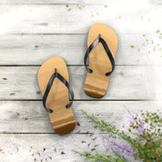 Flip-flops with ocean waves design on wooden planks.