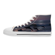 High-top sneakers with leaping dolphins in ocean waves at sunset.