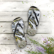Flip flops with a waterfall pattern on a wooden deck.