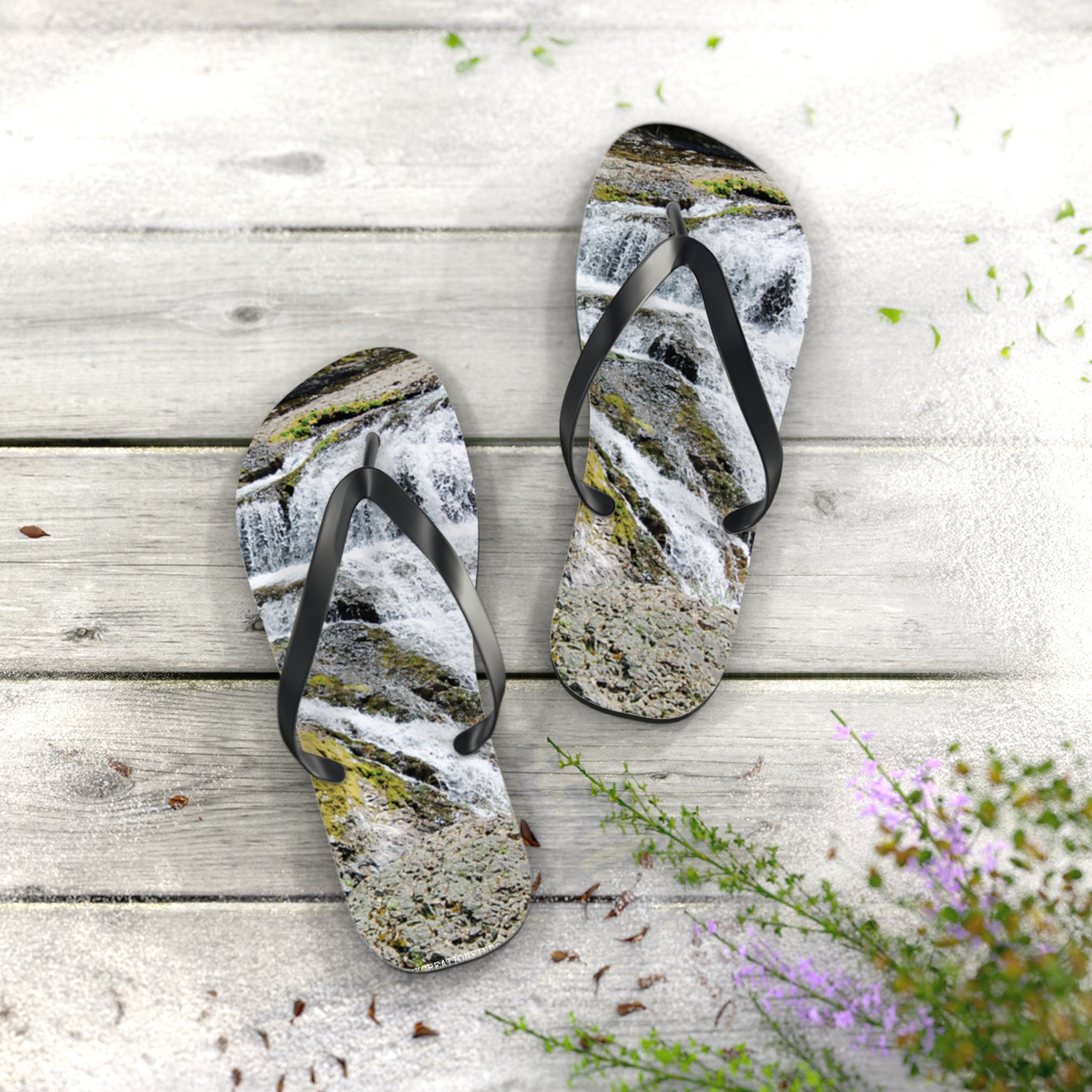 Flip flops with a waterfall pattern on a wooden deck.
