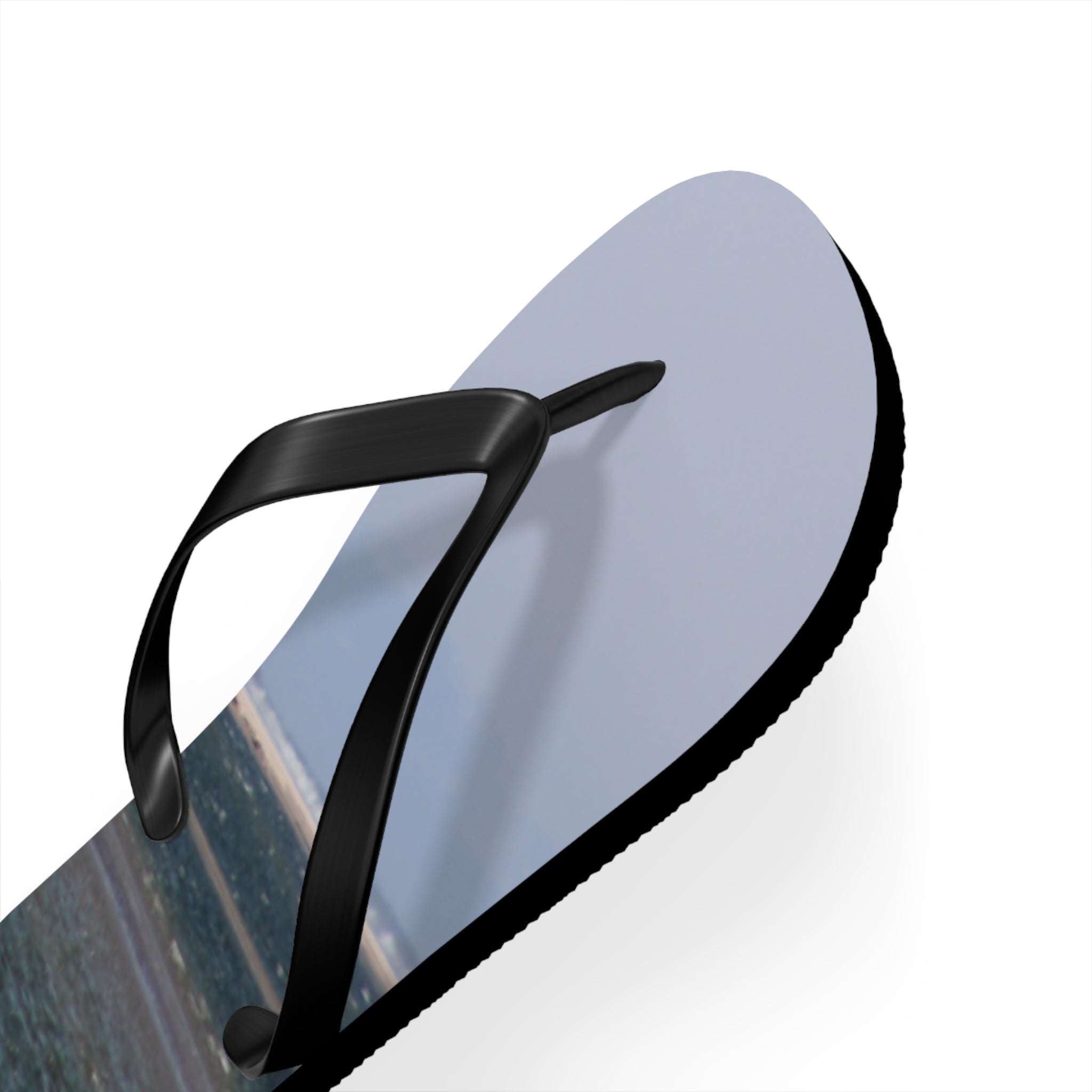 Light blue flip-flop with black straps, white sole, against a white background.