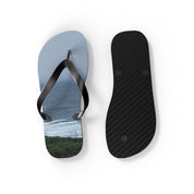 Flip-flops with ocean waves and foliage printed on one sole.