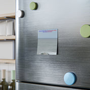 Magnetic note on refrigerator with text about beautiful worlds and the sea.