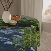 Round tablecloth with river and foliage pattern.