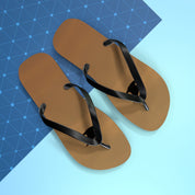Brown flip-flops with black straps on a blue geometric background.