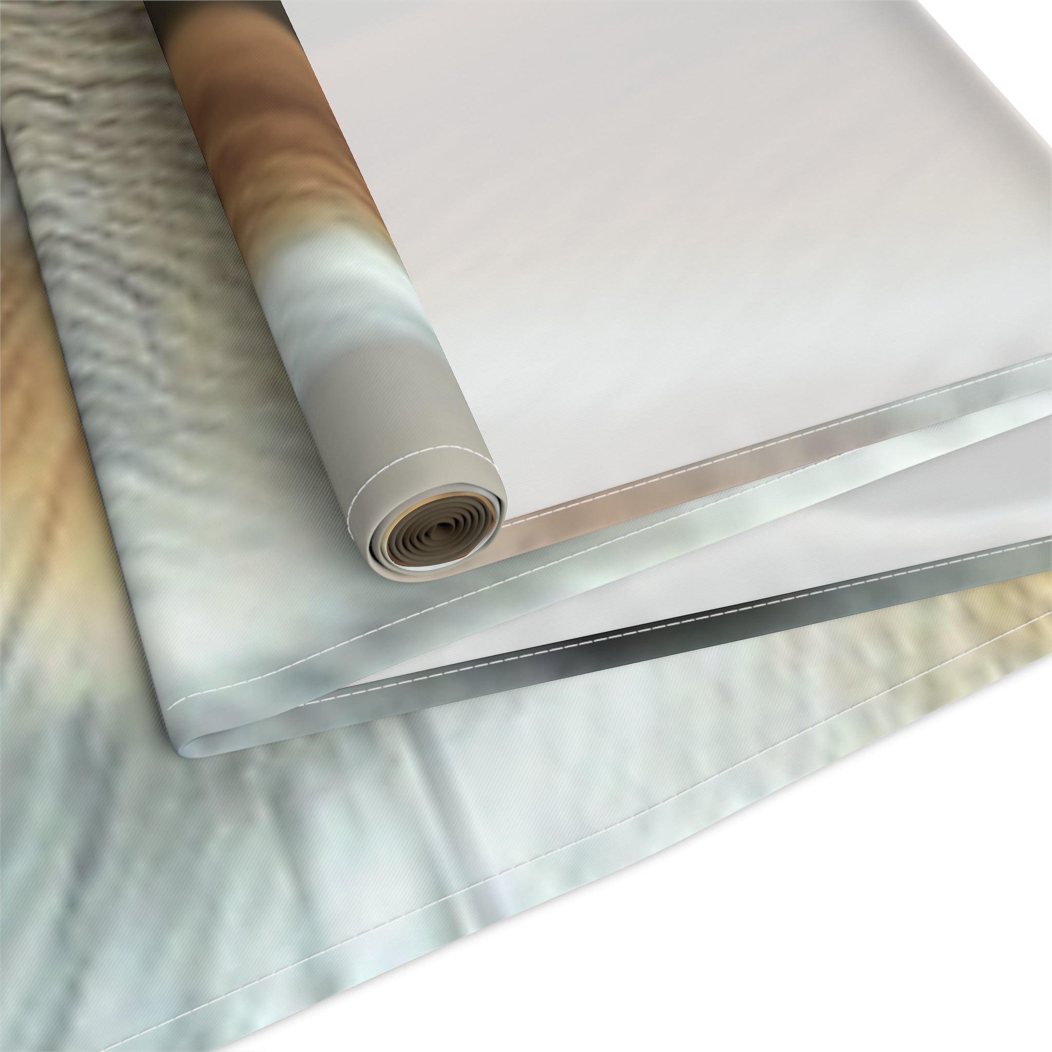 Rolled fabric with a blurred animal print pattern on a white background.