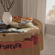 Orange tabby cat on a tablecloth with "FOREVER" text.