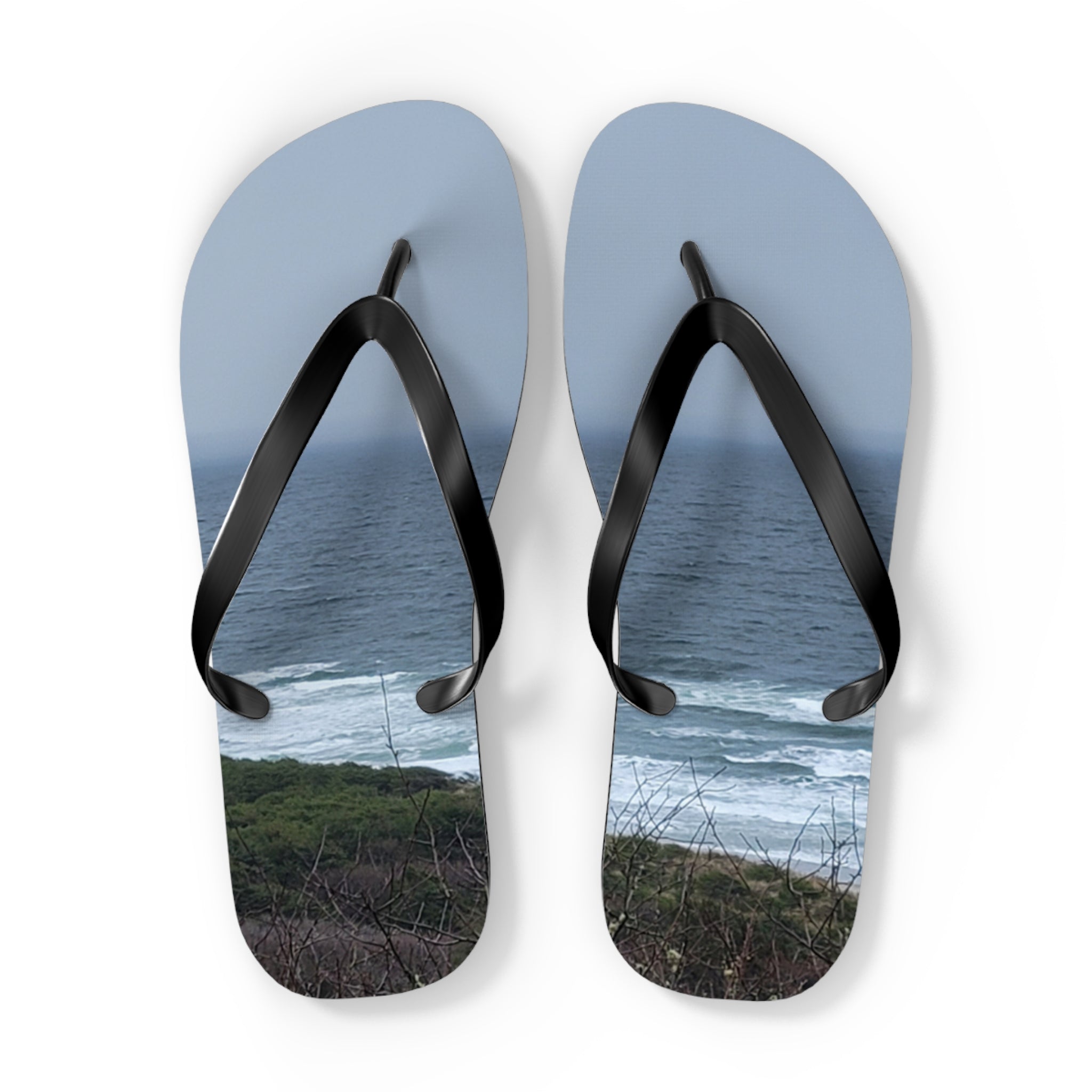 Flip-flops with a scenic ocean beach landscape printed on the soles.
