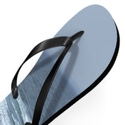 Light blue flip-flop with black straps on a white background.