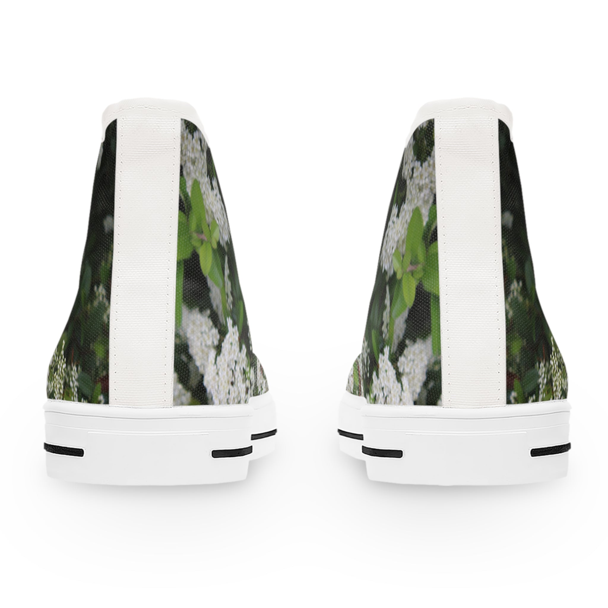 High-top sneakers with a floral print against a dark background.