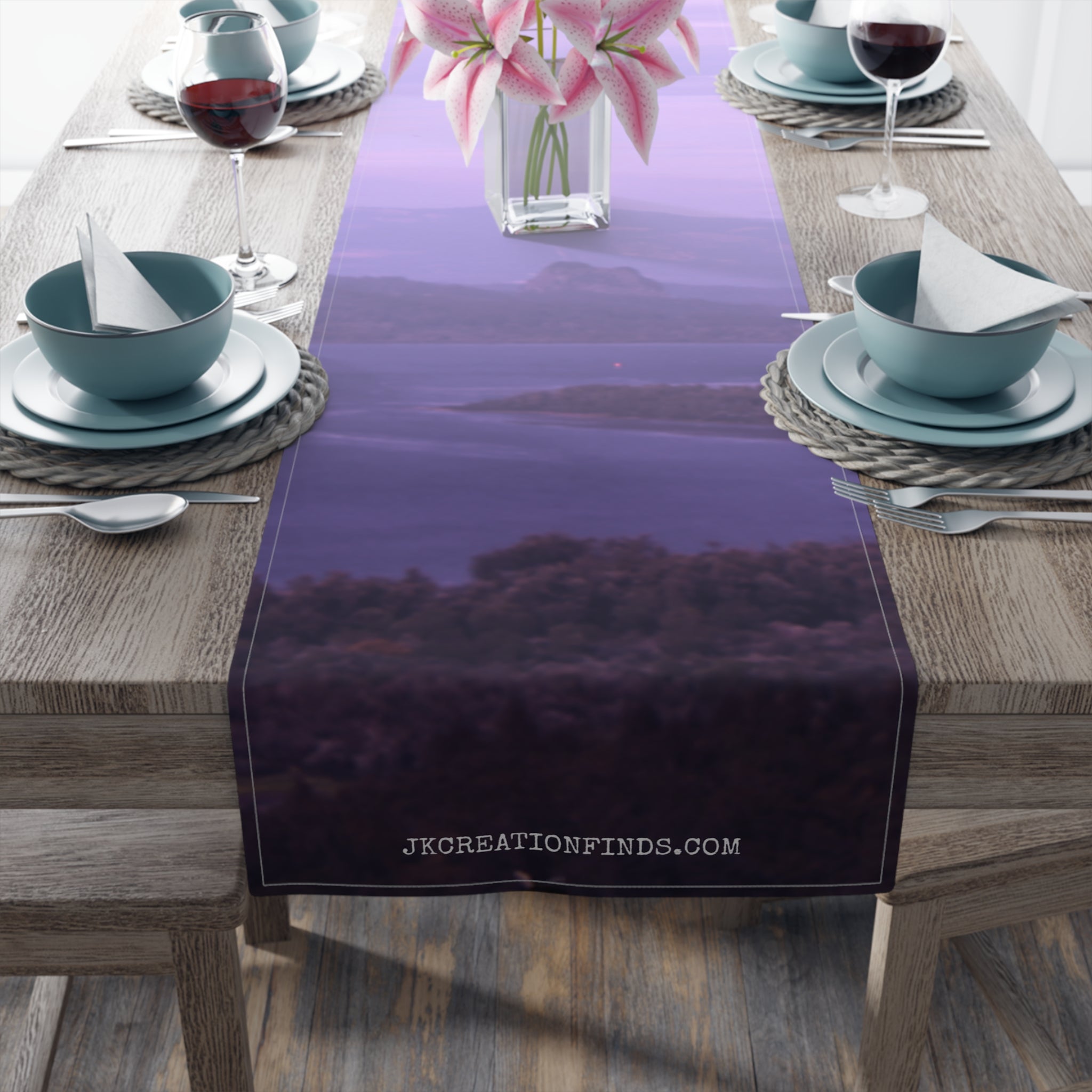 Table runner with a blurry landscape and website URL JKCREATIONFINDS.COM.