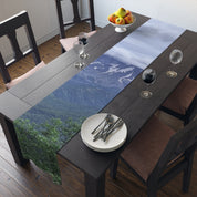 Table runner with mountain landscape print on a dining table.