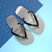 Gray flip-flops with black straps on a blue background.