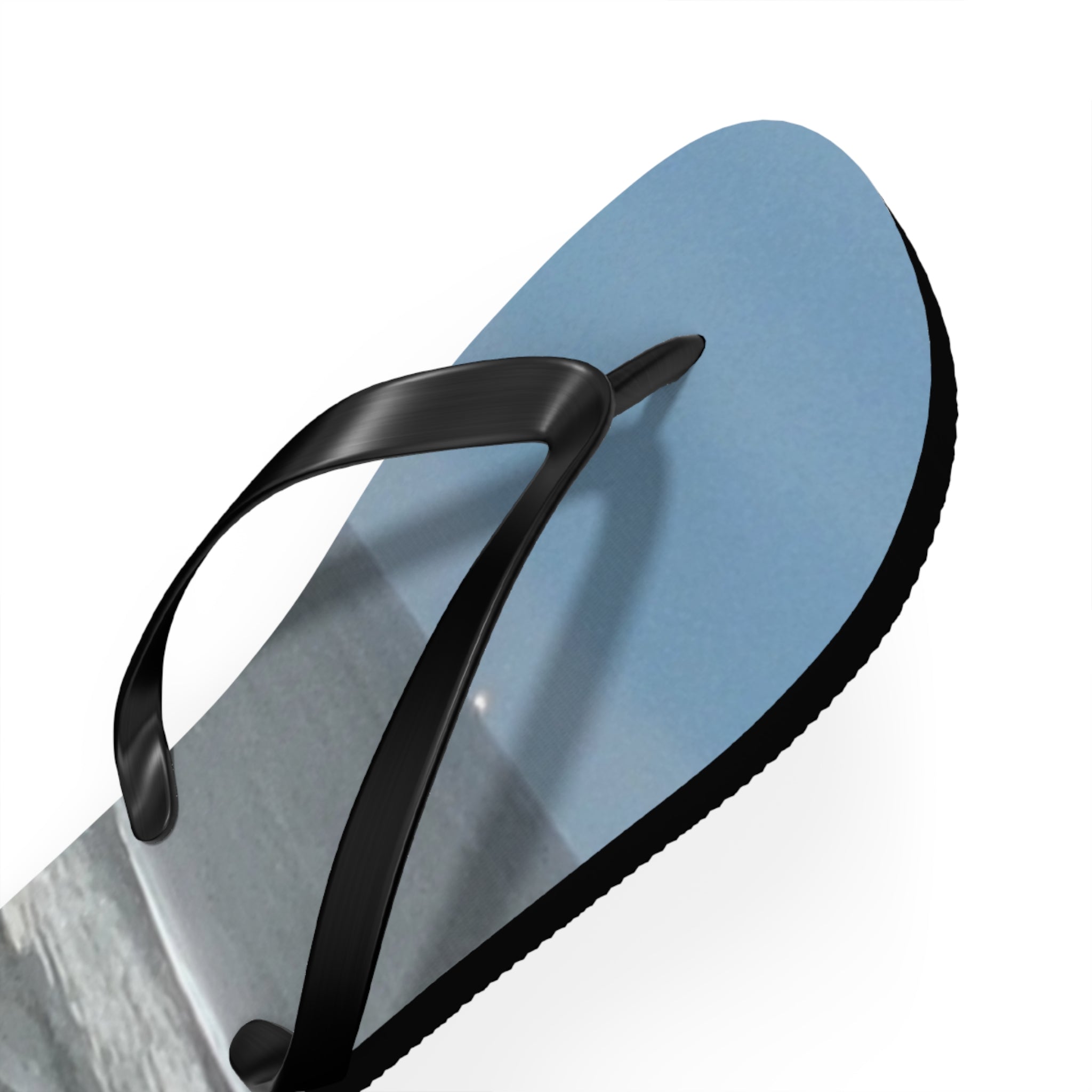 Blue flip-flop with a black strap and a beach scene on the sole.