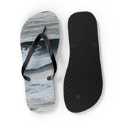 Flip-flops with a wave pattern on the soles and black straps.