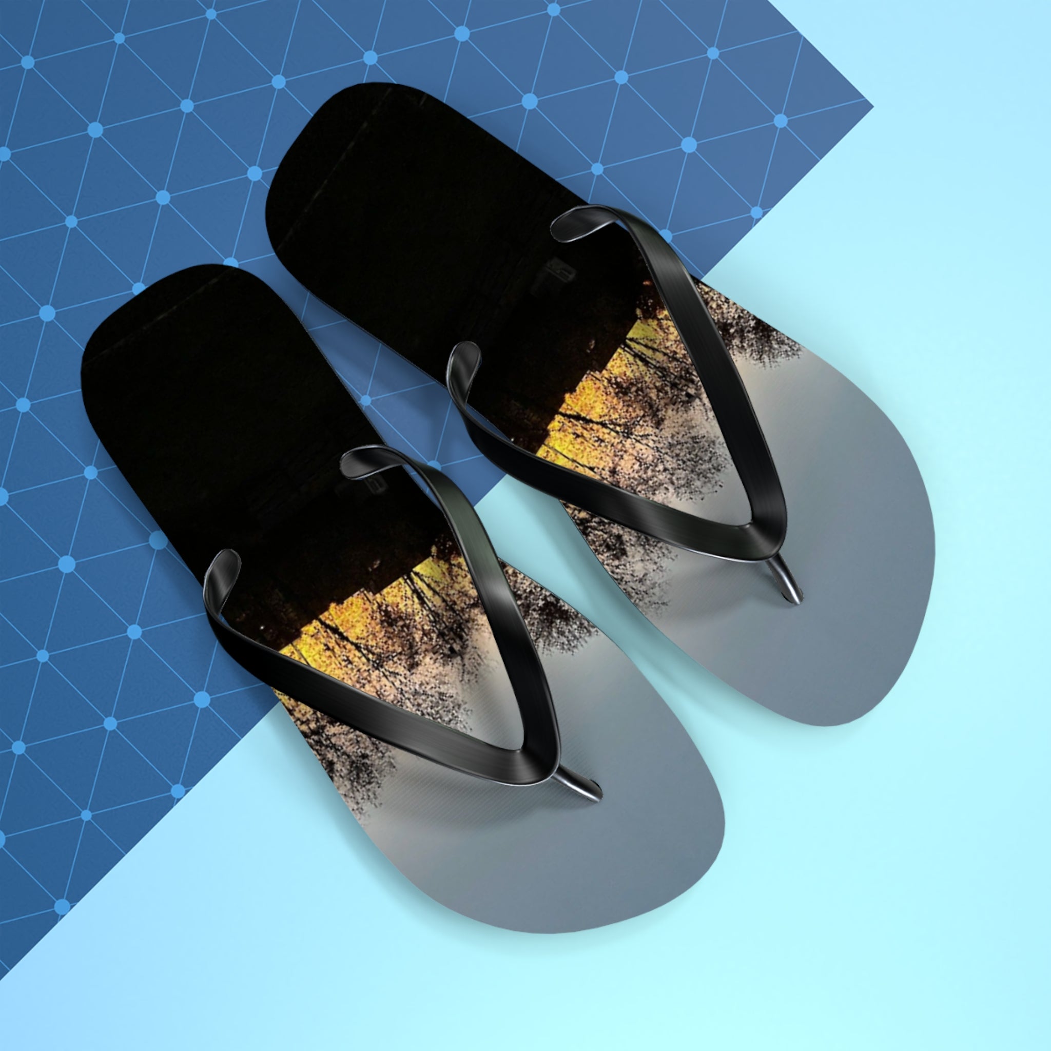 Black flip-flops with a sunset forest scene on the soles.
