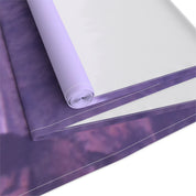 Rolled purple fabric with a white border and blurry purple pattern.
