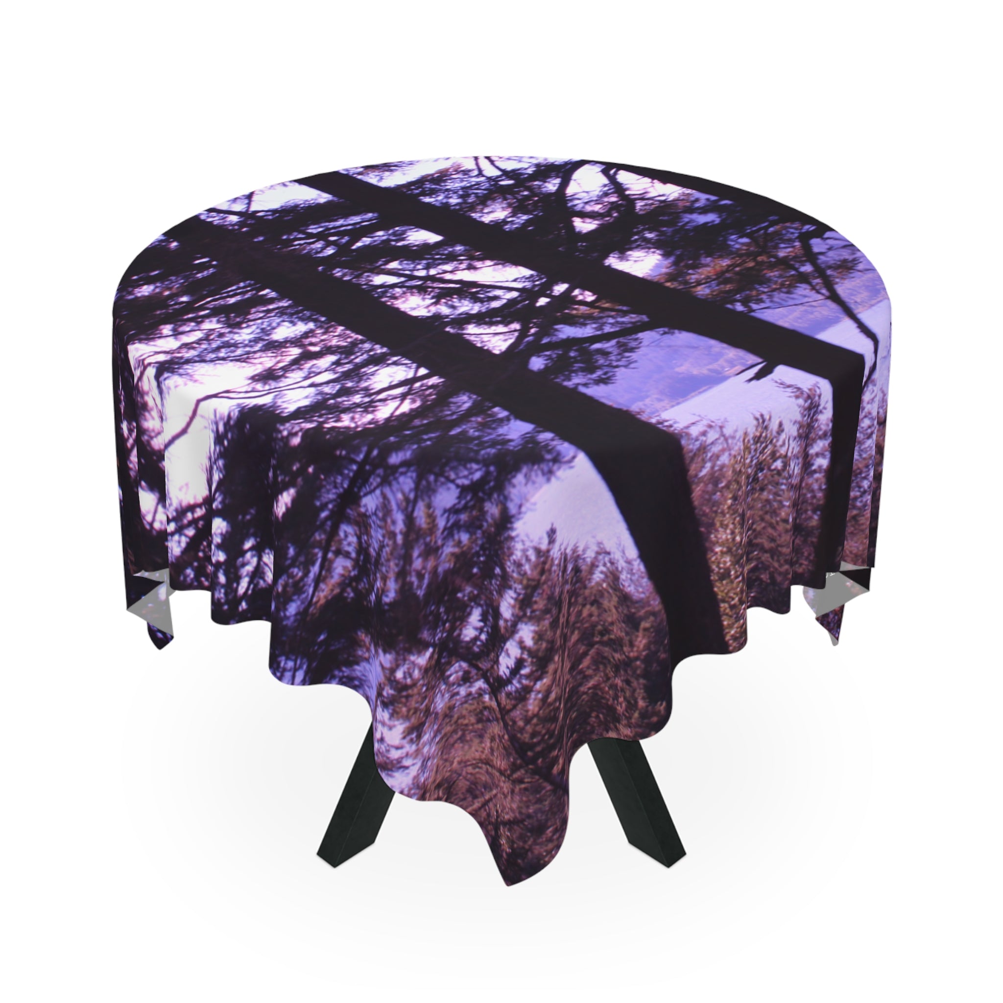 Round tablecloth with purple forest tree reflection on white background.