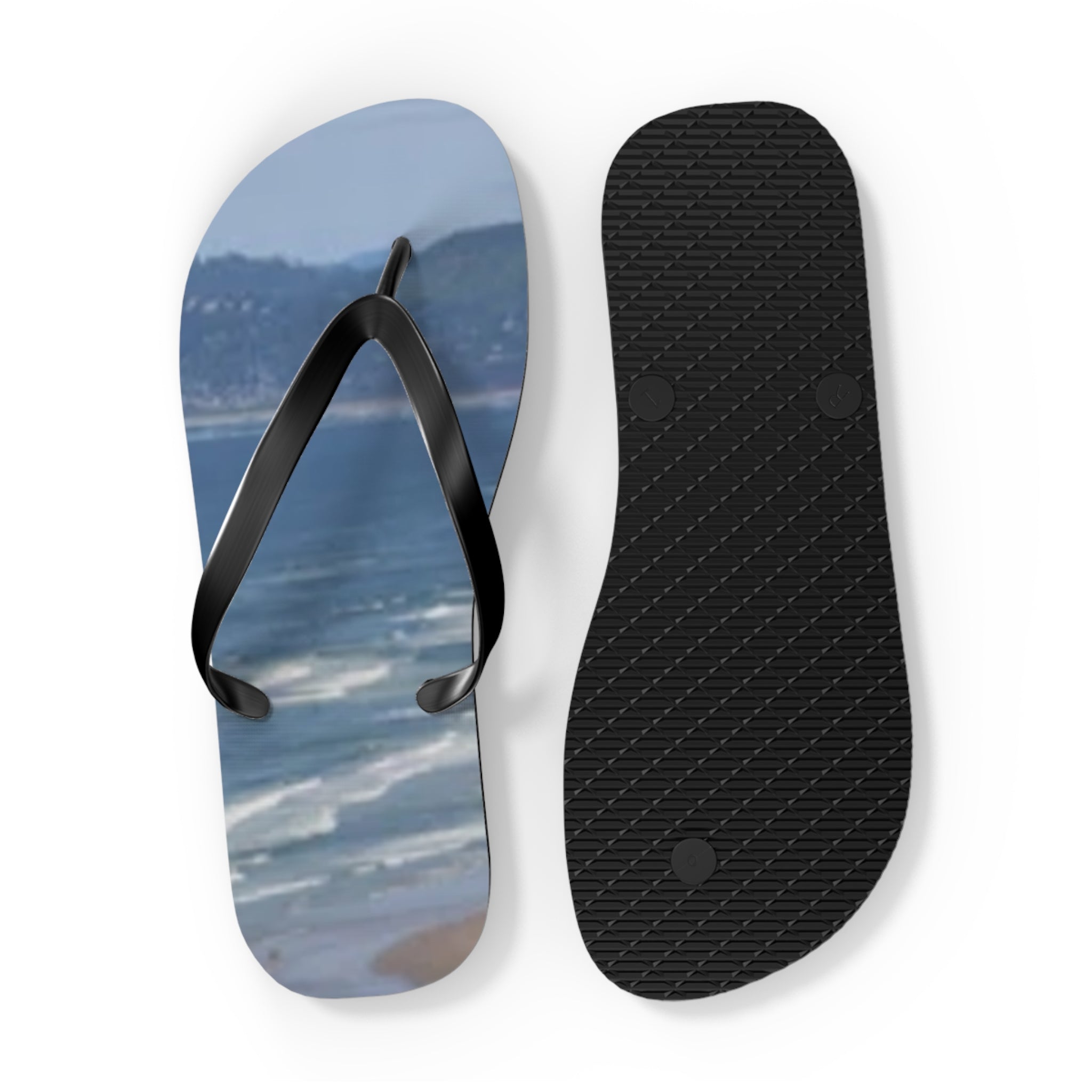 Flip flops with a beach scene on one sole and black sole on the other.