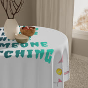 White tablecloth with colorful text and a cartoon eye.