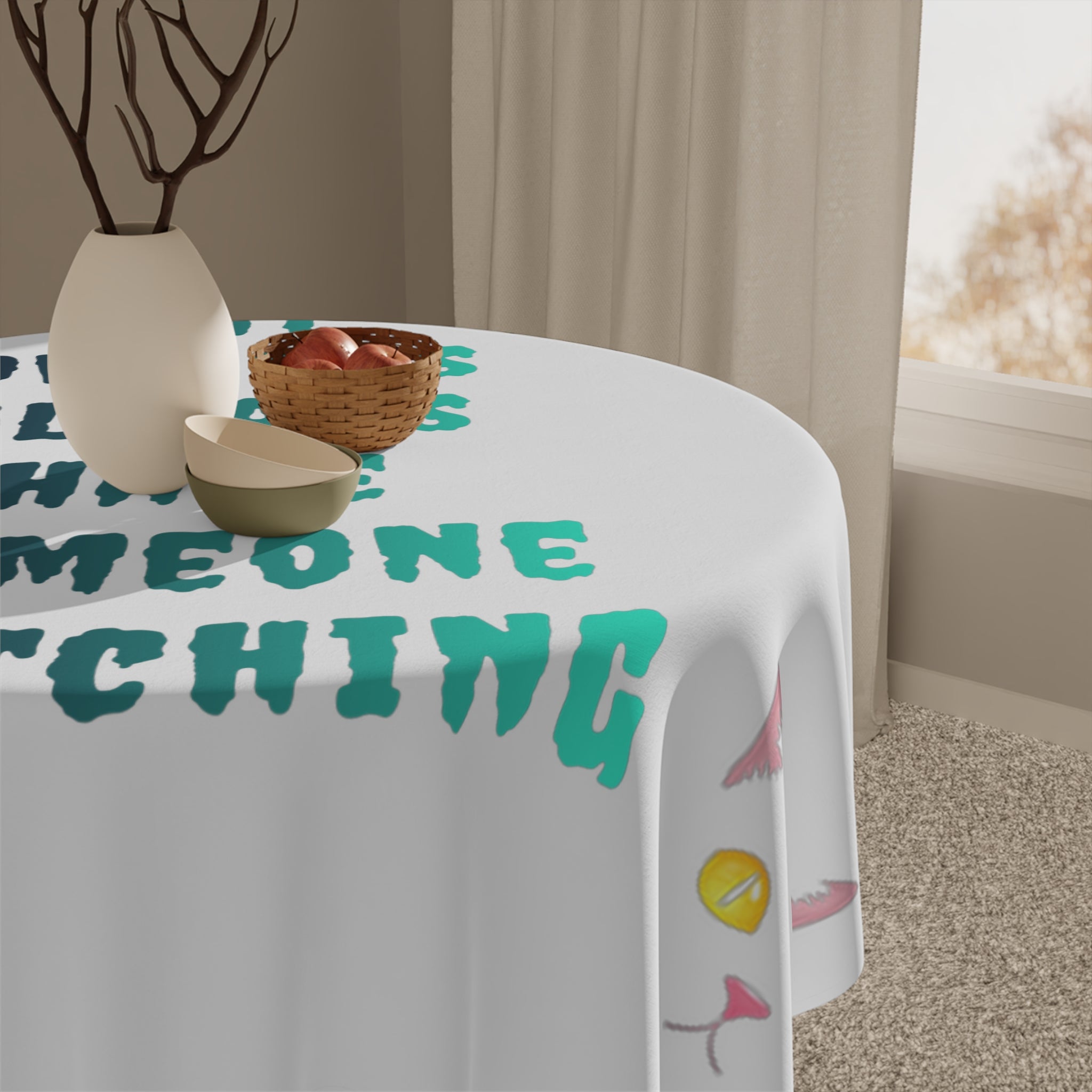 White tablecloth with colorful text and a cartoon eye.