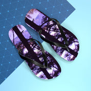 Purple tree canopy pattern on black flip-flops with blue geometric background.