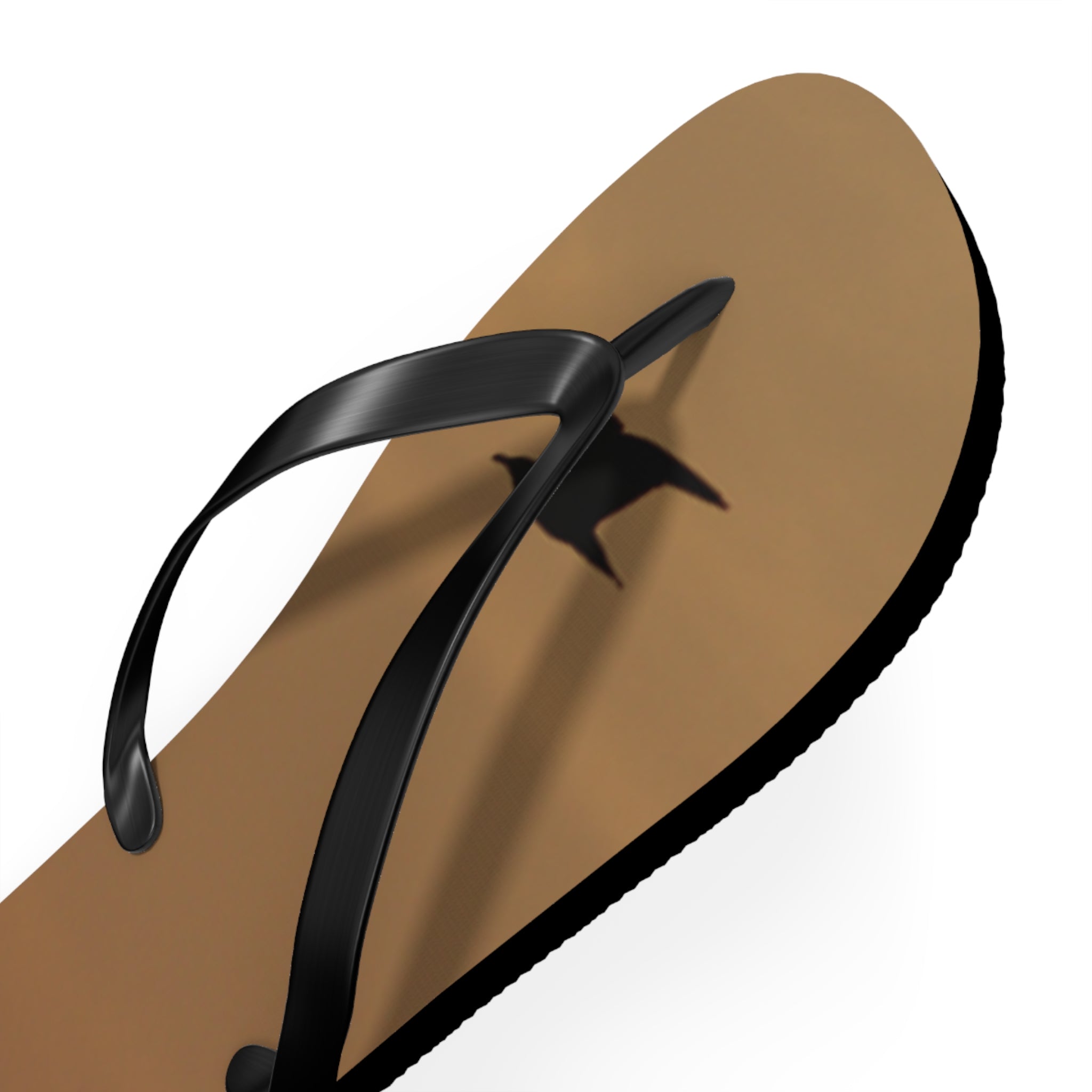 Brown flip-flop with black strap, casting a shadow.