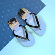 Light blue flip-flops with a desert landscape print on a blue background.