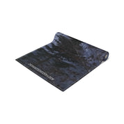 Rolled dark fabric with subtle pine tree pattern and website URL.