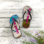 Laguna Beach flip-flops on a wooden surface with flowers.