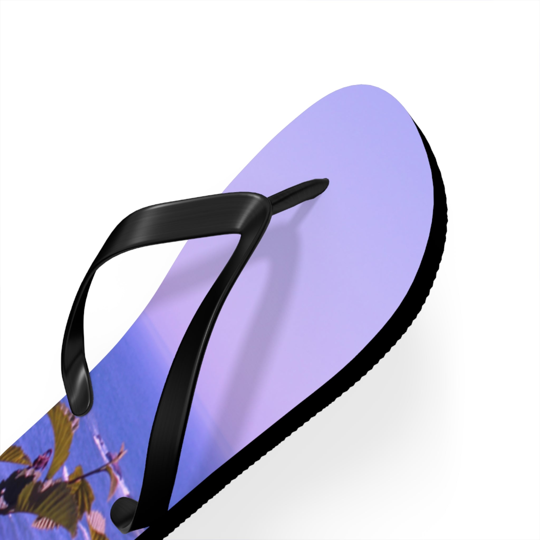 Purple flip-flop with beach scene on sole, black straps, white background.