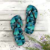 Flip-flops with sea turtles on a wooden surface with flowers.