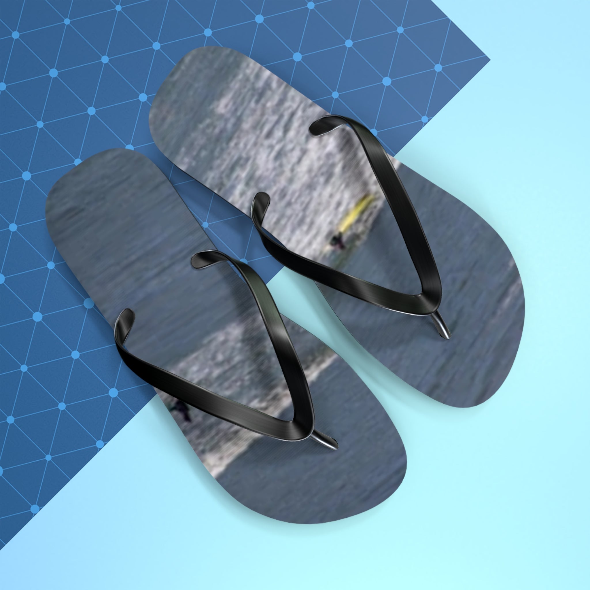 Flip-flops with a surfer on a wave on a blue and light blue background.